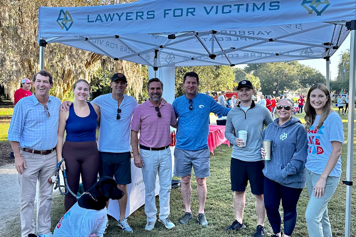Image of the Yarborough Applegate team standing outside beneath a tent