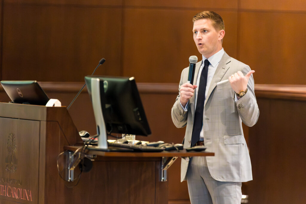 Liam Duffy speaks at a podium during SCAJ's Young Lawyers Symposium